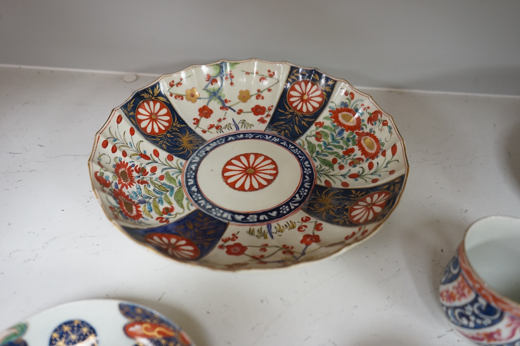 A Worcester Lord Henry Thynne type fluted tea bowl and saucer, c.1780, a group of Worcester Queen Charlotte pattern tea and coffee wares, c.1790-1810, two Worcester Kakiemon style dishes, largest 21cm in diameter